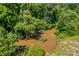 Aerial view of a brown creek in a lush green forest at 1043 Linneys Mill Rd, Union Grove, NC 28689