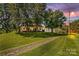 Charming home nestled amongst mature trees and lush landscaping, features a private driveway at 1043 Linneys Mill Rd, Union Grove, NC 28689