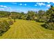Expansive view of a lush green field with trees in the distance at 1043 Linneys Mill Rd, Union Grove, NC 28689