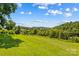 Expansive view of a lush green field with trees and mountains in the distance at 1043 Linneys Mill Rd, Union Grove, NC 28689