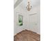Bright foyer with wood-look floors, a decorative chandelier, and a door with unique glass detail at 1043 Linneys Mill Rd, Union Grove, NC 28689