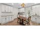 Eat-in kitchen with white cabinets, granite countertops and wood flooring at 1043 Linneys Mill Rd, Union Grove, NC 28689