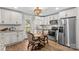 Modern kitchen with stainless steel appliances, white cabinetry, and an adjacent breakfast nook at 1043 Linneys Mill Rd, Union Grove, NC 28689