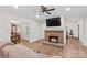 Cozy living room with a brick fireplace, ceiling fan, and views into other living spaces at 1043 Linneys Mill Rd, Union Grove, NC 28689