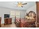 Luxurious main bedroom with a carved, four-poster bed and lots of light at 1043 Linneys Mill Rd, Union Grove, NC 28689