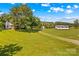 Aerial view of the property with expansive grassy yard and outbuildings at 1043 Linneys Mill Rd, Union Grove, NC 28689