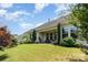 Well-maintained backyard features a covered patio area, lush green lawn, and manicured landscaping, offering an ideal outdoor retreat at 11225 Black Brant Ln, Charlotte, NC 28278