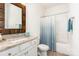 Bathroom with granite countertops, custom wood framed mirror, and shower/tub combination at 11225 Black Brant Ln, Charlotte, NC 28278