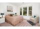 Cozy bedroom featuring natural light, carpet, and a comfortable seating area at 11225 Black Brant Ln, Charlotte, NC 28278