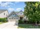Charming home featuring a manicured front yard, attached two-car garage, and craftsman-style architectural details at 11225 Black Brant Ln, Charlotte, NC 28278