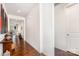 Inviting hallway with hardwood floors, flowing seamlessly into adjacent living spaces and leading to a closed door at 11225 Black Brant Ln, Charlotte, NC 28278