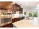 Modern kitchen with a central island, stainless steel appliances, white countertops, and dark wood cabinetry at 11225 Black Brant Ln, Charlotte, NC 28278