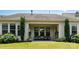 A covered patio offers an inviting outdoor living space with comfortable seating and serene views of the landscaped backyard at 11225 Black Brant Ln, Charlotte, NC 28278