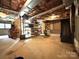 Unfinished basement with concrete floor, exposed insulation, and shelving units at 1335 33Rd Avenue Ne Dr, Hickory, NC 28601