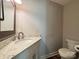 Half bathroom featuring a marble vanity top, a sink, and a toilet at 1335 33Rd Avenue Ne Dr, Hickory, NC 28601