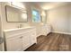 Bright bathroom featuring double vanity, hardwood floors and updated fixtures at 1335 33Rd Avenue Ne Dr, Hickory, NC 28601