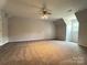 Large bedroom with neutral carpet, ceiling fan, and natural light at 1335 33Rd Avenue Ne Dr, Hickory, NC 28601