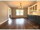 Dining area featuring hardwood floors, stylish lighting, and custom cabinetry at 1335 33Rd Avenue Ne Dr, Hickory, NC 28601
