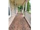 Inviting brick front porch with classic white railings and brick flooring at 1335 33Rd Avenue Ne Dr, Hickory, NC 28601