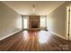 Spacious living room featuring hardwood flooring, a brick fireplace, and outdoor access at 1335 33Rd Avenue Ne Dr, Hickory, NC 28601