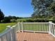 Back deck overlooks a vast green field with a gorgeous tree for shade at 147 Dutchman Rd, Harmony, NC 28634