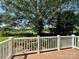 Enjoy this back deck overlooking a green field with a gorgeous tree for shade at 147 Dutchman Rd, Harmony, NC 28634
