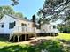 Exterior of home showing a lush green yard, a metal roof, and dual decks at 147 Dutchman Rd, Harmony, NC 28634