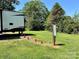 Lot featuring RV hookups with lush grass and mature trees surrounding the property at 147 Dutchman Rd, Harmony, NC 28634
