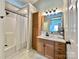 Well-lit bathroom features a vanity with storage, tiled floors, and walk in shower at 147 Dutchman Rd, Harmony, NC 28634
