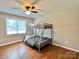 Bedroom featuring a bunkbed with wooden floors and a ceiling fan at 147 Dutchman Rd, Harmony, NC 28634