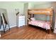 Bedroom with hardwood floors, bunk beds, and a chest of drawers with mirror at 147 Dutchman Rd, Harmony, NC 28634
