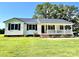 Charming single-story home with a covered front porch, black shutters, and a metal roof at 147 Dutchman Rd, Harmony, NC 28634