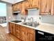 Efficient kitchen with wood cabinets, black appliances, and durable countertops at 147 Dutchman Rd, Harmony, NC 28634