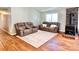 Cozy living room featuring hardwood floors, a wood burning stove and comfortable seating area at 147 Dutchman Rd, Harmony, NC 28634