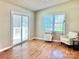 Bright living room with hardwood floors, neutral walls, and a sliding glass door to the deck at 147 Dutchman Rd, Harmony, NC 28634