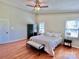 Relax in this main bedroom with a fan, hardwood floors, and bright, neutral colored walls at 147 Dutchman Rd, Harmony, NC 28634