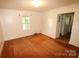 Modest bedroom with hardwood floors, a window, and a doorway leading to a closet at 1541 Kings Rd, Shelby, NC 28150