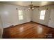 Bright bedroom featuring hardwood floors, a ceiling fan, and natural light from two windows at 1541 Kings Rd, Shelby, NC 28150