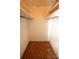 Compact closet space with wood floors and basic wood shelves and hanging rod at 1541 Kings Rd, Shelby, NC 28150