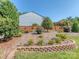 Backyard featuring terraced garden beds and a well-maintained lawn, perfect for outdoor enjoyment at 15739 Circlegreen Dr, Charlotte, NC 28273