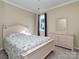 Serene bedroom with pastel furniture and seashell patterned bedding, creating a tranquil coastal vibe at 15739 Circlegreen Dr, Charlotte, NC 28273