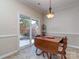 Dining area showcases a wooden table set near a sliding glass door, filling the space with natural light at 15739 Circlegreen Dr, Charlotte, NC 28273