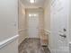 Light and bright foyer with durable floors, bench and neutral decor leading into the home at 15739 Circlegreen Dr, Charlotte, NC 28273