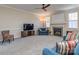 Bright living room with fireplace, ceiling fan, neutral walls and carpet, plus comfortable seating at 15739 Circlegreen Dr, Charlotte, NC 28273