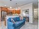 Cozy living room transitioning into a kitchen with wooden cabinets and stainless steel appliances at 15739 Circlegreen Dr, Charlotte, NC 28273