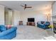 Inviting living room with ceiling fan, fireplace, neutral carpet and wall trim at 15739 Circlegreen Dr, Charlotte, NC 28273