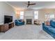 Cozy living room with plush carpet, fireplace, ceiling fan and comfortable furniture at 15739 Circlegreen Dr, Charlotte, NC 28273