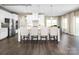 Open kitchen with stainless steel appliances, white cabinetry, a large island with barstool seating, and hardwood flooring at 2020 Bramble Hedge Rd # 3276, Indian Trail, NC 28079