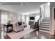 Cozy living room featuring hardwood floors, neutral tones, plush furniture, large windows, and a staircase at 2020 Bramble Hedge Rd # 3276, Indian Trail, NC 28079