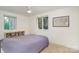 Bright and airy bedroom featuring a comfortable bed, ample natural light, and closet space at 207 N Dotger Ave # C14, Charlotte, NC 28207